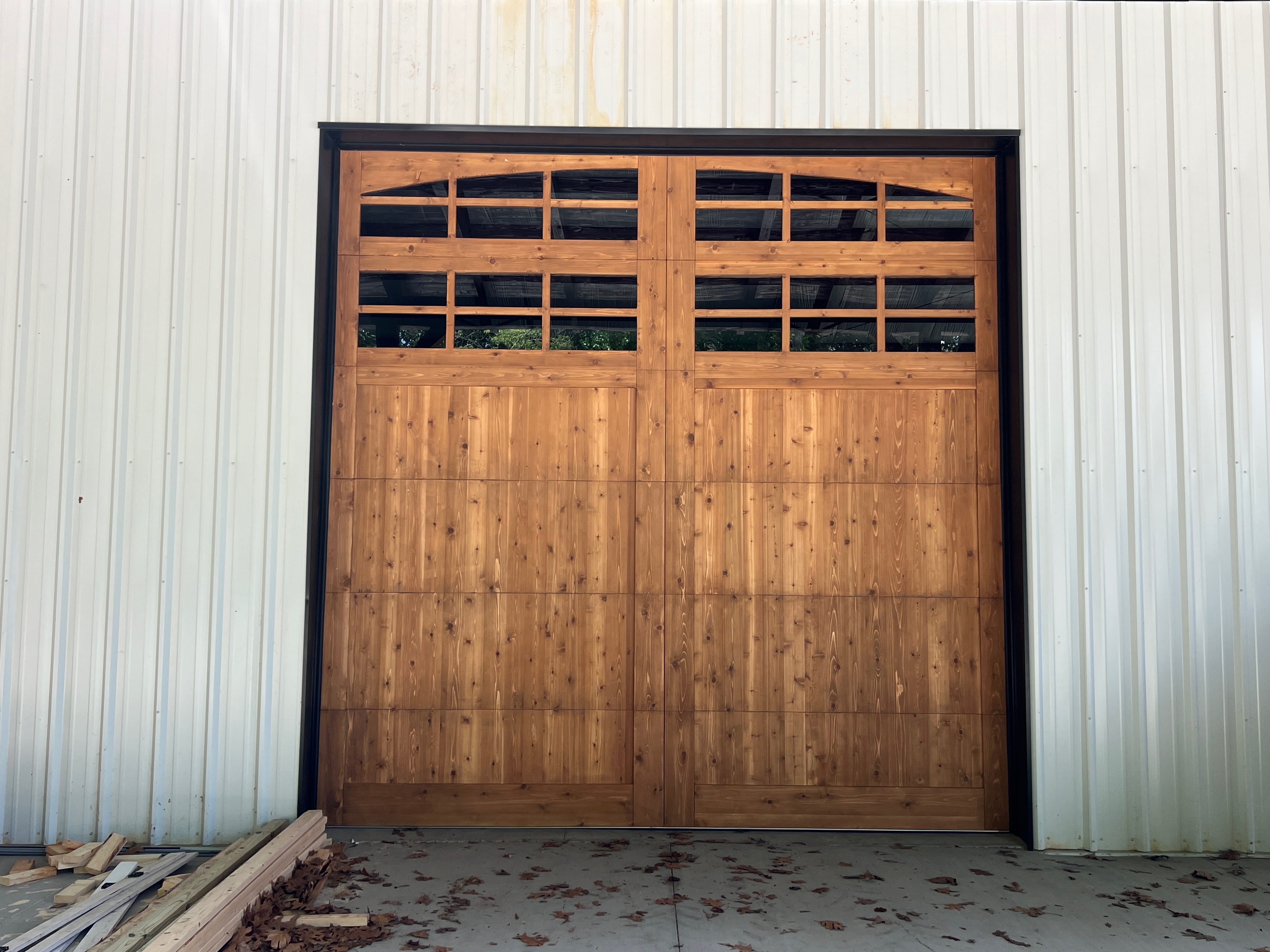Handcrafted cedar flat panel garage door with multi-pane windows by Old Wood Dynasty