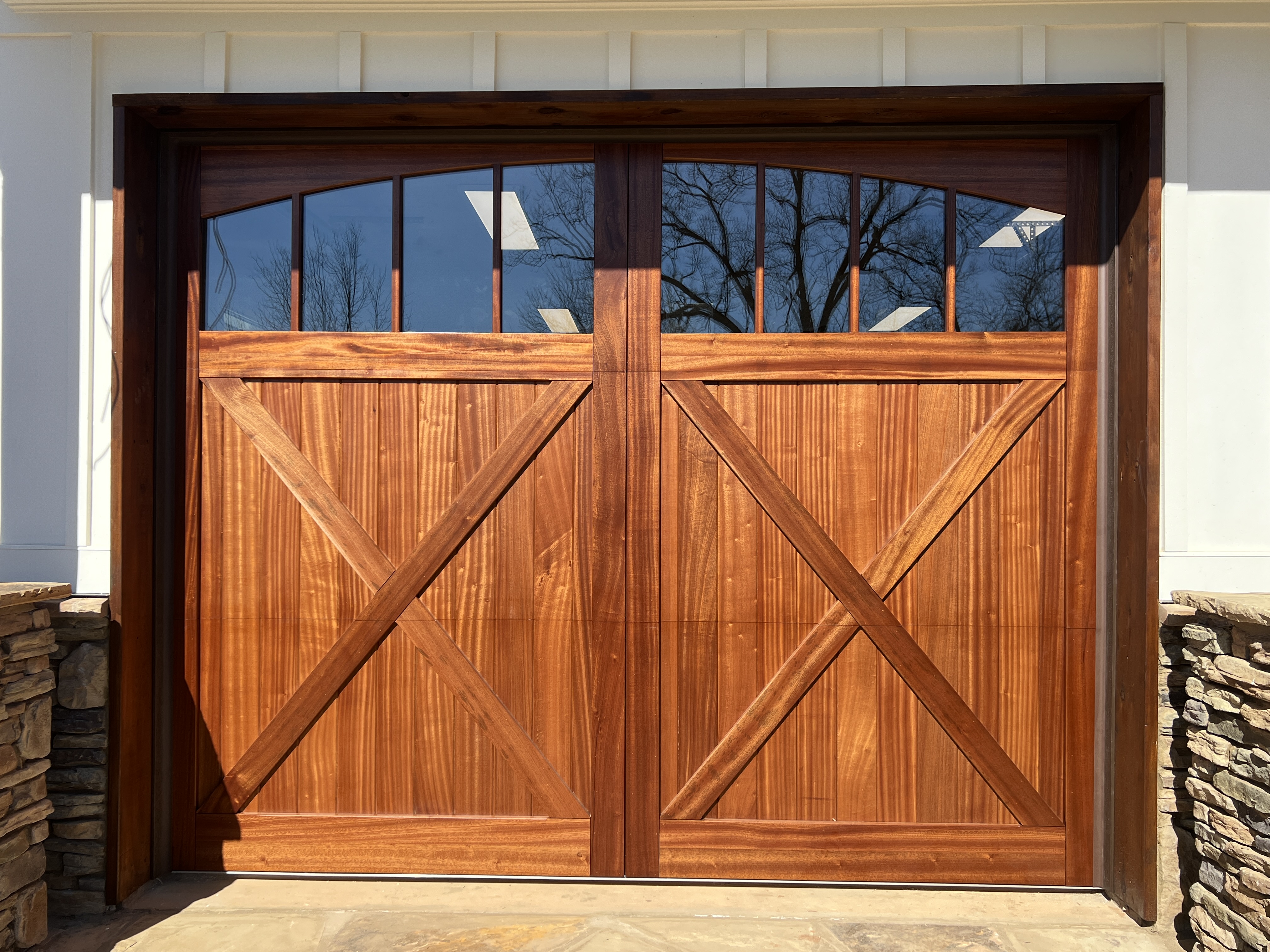 Custom sapele wood crossbuck garage door with arched windows by Old Wood Dynasty